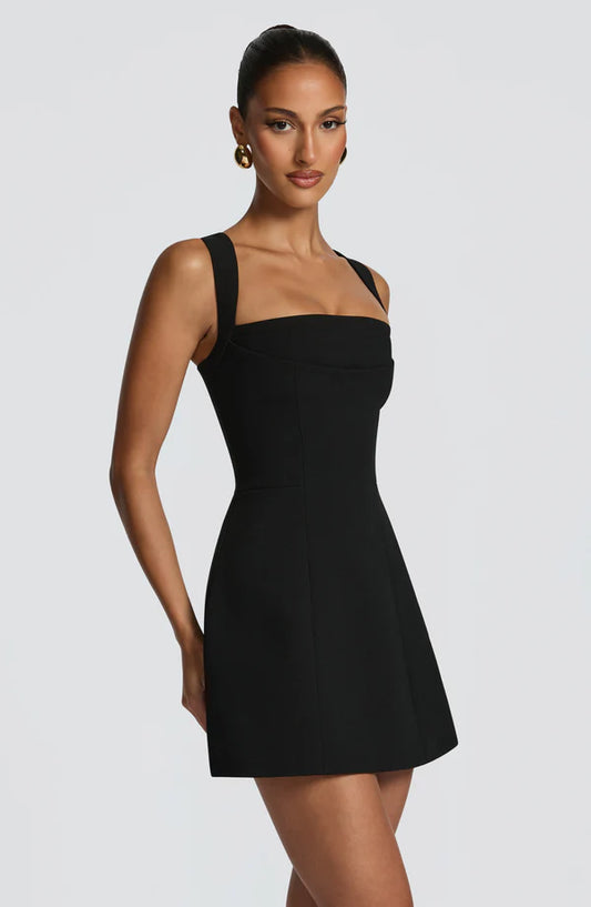 Black mini dress with high neckline and bubble hem silhouette