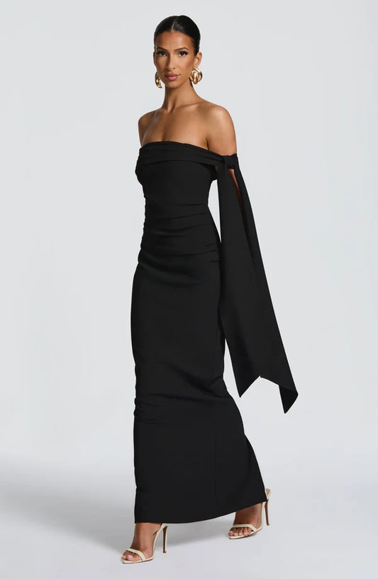 Side view of the Addie Maxi Dress highlighting the graceful drape, flattering fit, and modern evening wear design.